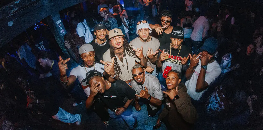 A big group of friends posing together at the baile funk party