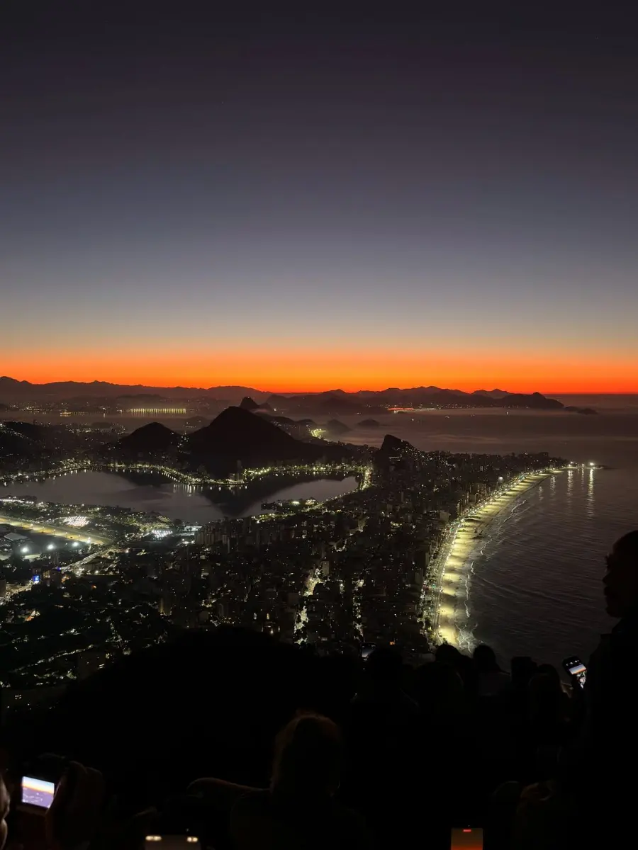 Panoramic dusk view of Copacabana beach, the lagoon and Rio de Janeiro from a mountaintop