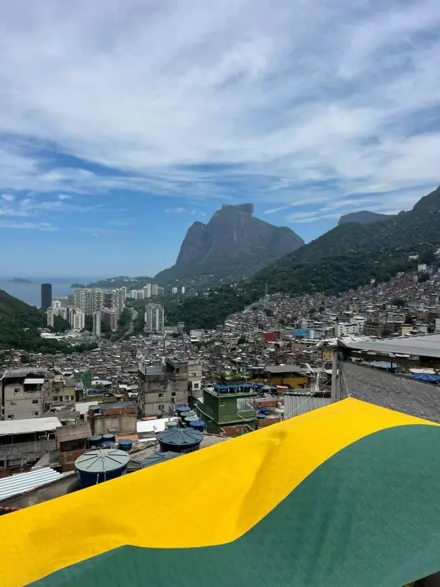View of Rocinha favela with Pedra da Gavea mountain and a Brazilian flag