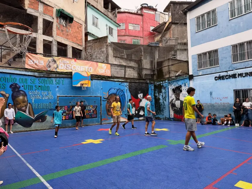 A game in progress on Rocinha's community court, surrounded by painted murals